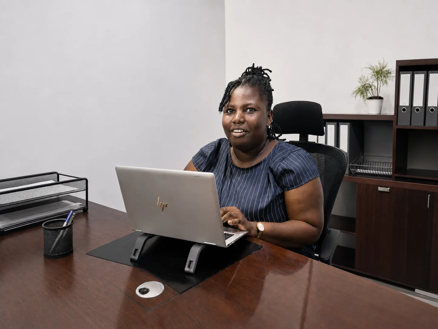 An Alexander Johnson & Co professional supporting client work at a laptop