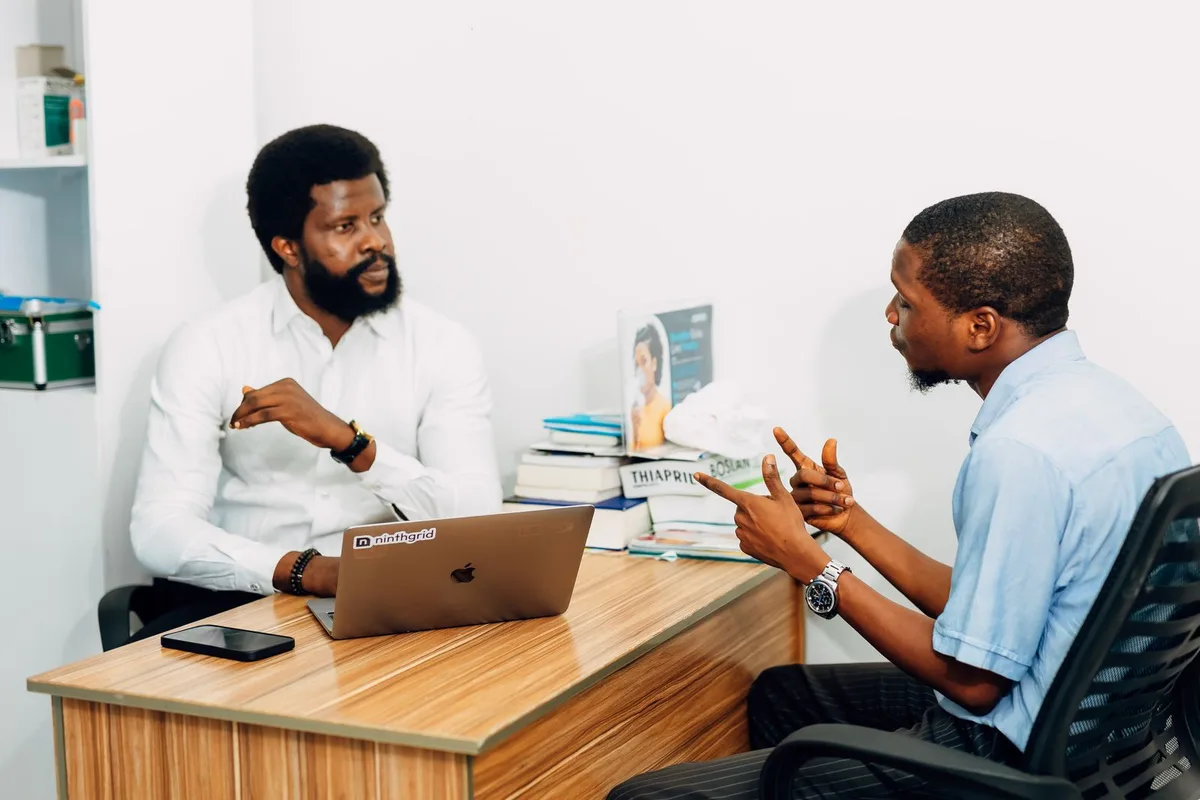 A mature Nigerian adviser in a one-to-one client consultation
