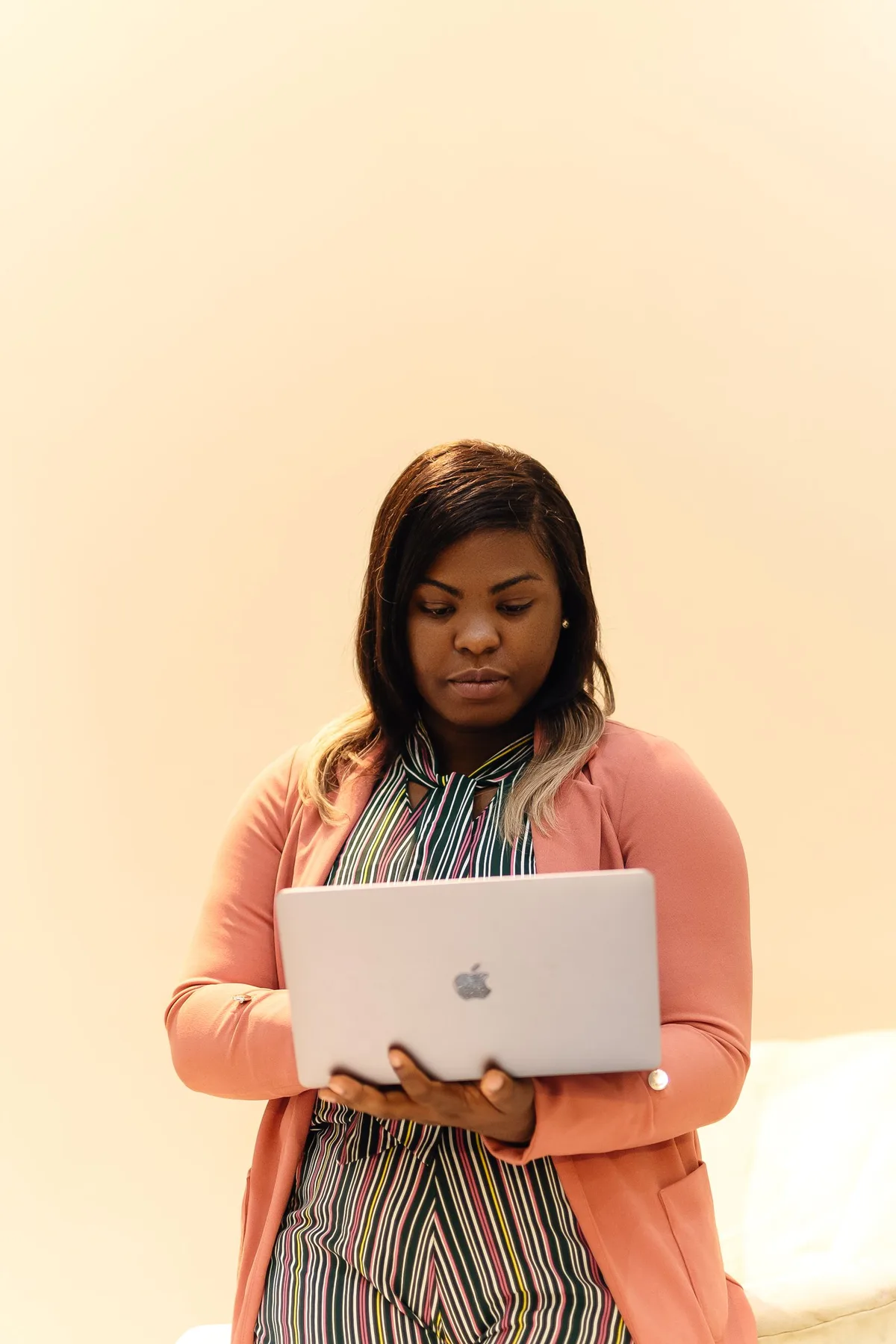 A Nigerian finance professional reviewing work on a laptop