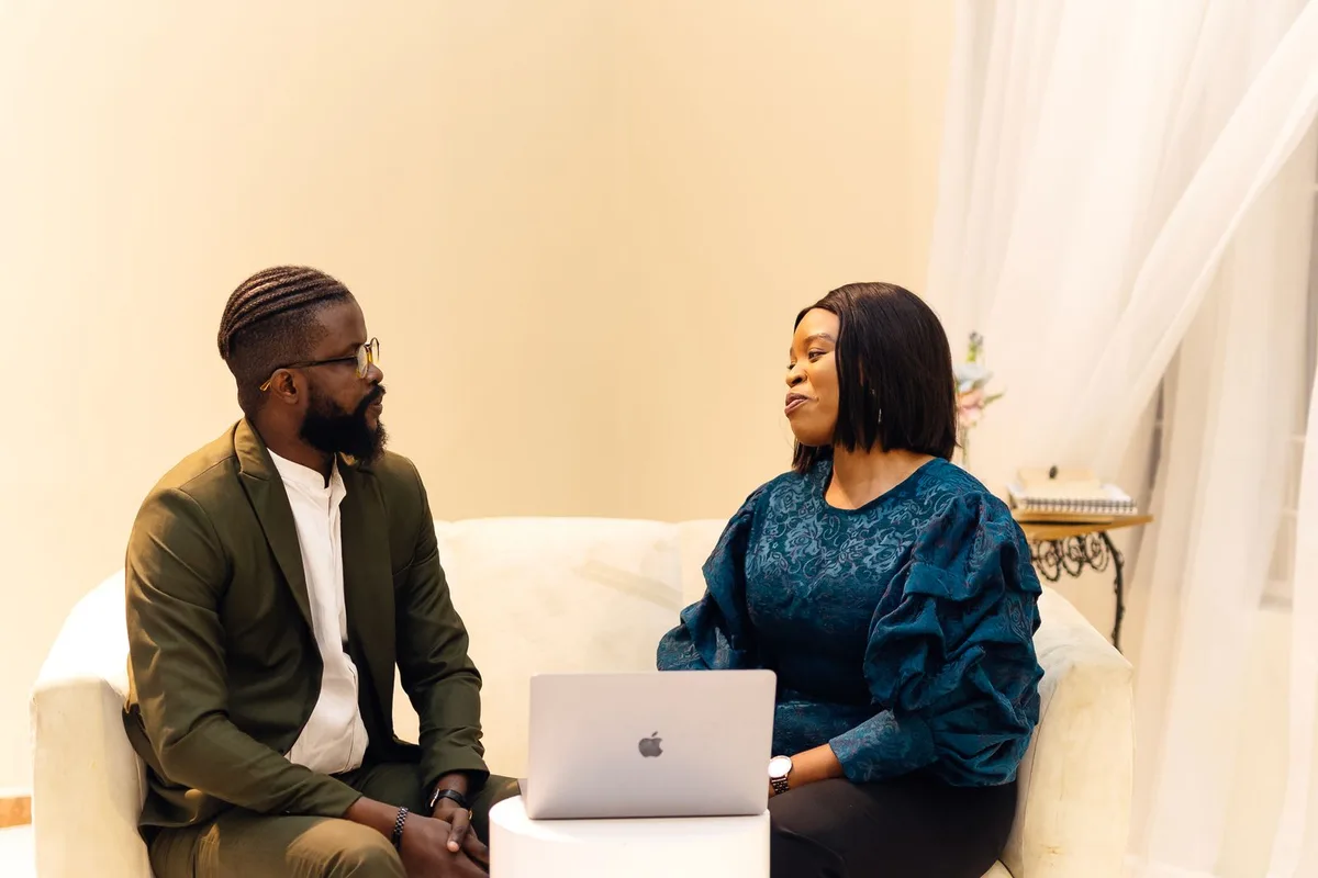 A woman and man discussing business needs in a Lagos office