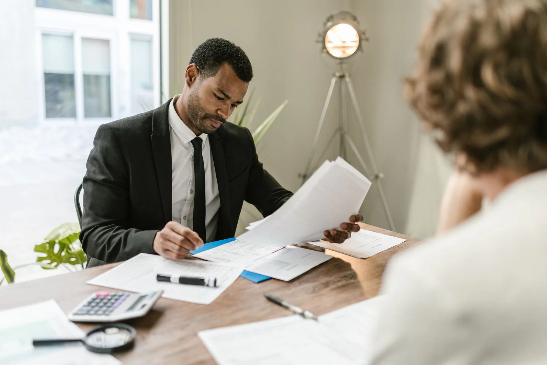 A Black accounting adviser reviewing financial information with a client