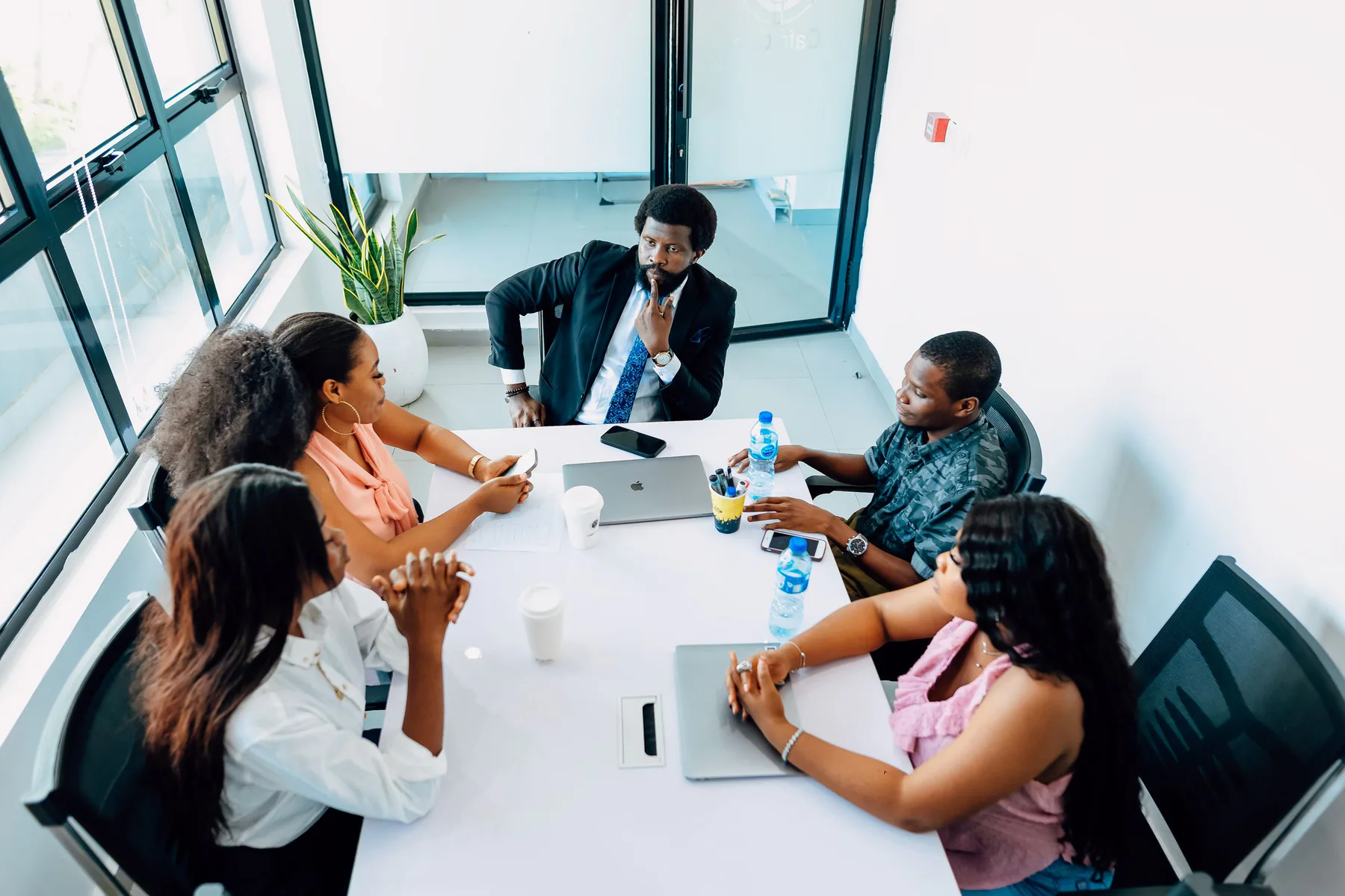 Business professionals discussing an assignment in a Lagos meeting room